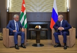 Russian President Vladimir Putin (right) meets Abkhaz leader Raul Khajimba in Sochi in August 2019