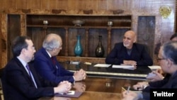 Afghan President Ashraf Ghani (right) meets with U.S. envoy Zalmay Khalilzad in Kabul on April 3.