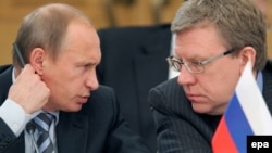 Prime Minister Vladimir Putin and former Finance Minister Aleksei Kudrin, who resigned in late September after a spat with President Dmitry Medvedev.