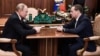 Russian President Vladimir Putin (left) meets with Dmitry Medvedev at the Kremlin in Moscow on January 15.