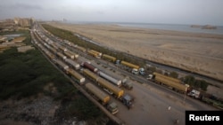 Fuel tankers used to carry fuel for NATO forces in Afghanistan stand idle at a compound in Karachi in May.