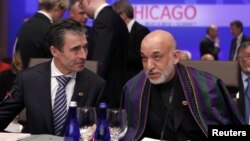 NATO Secretary-General Anders Fogh Rasmussen (left) and Afghanistan's President Hamid Karzai at the security alliance's summit in Chicago on May 21.