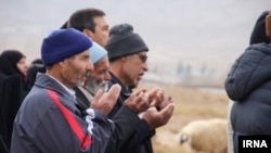 Residents of Qaen pray together for rain in the deserts around the Iranian city. 