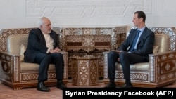 Syrian President Bashar al-Assad (right) meets with Iranian Foreign Minister Mohammad Javad Zarif in Damascus on April 16, 2019.