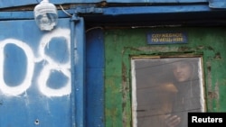 A migrant worker from Tajikistan looks through the window of a building at a vegetable market on the outskirts of Moscow on November 11.