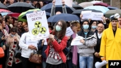 Environmental activists protest in front of the U.S. Embassy in Tirana on November 12.