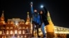 Young people turn on the flashlights of their mobile phones in support of jailed opposition politician Aleksei Navalny near Red Square in Moscow on February 14.