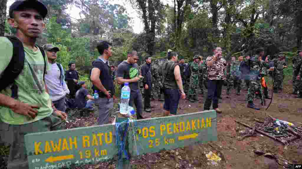 Soldiers and members of a search-and-rescue team rushed to the crash site in hopes that some of the 50 or so passengers and crew survived.