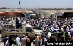 Those stranded at the border move to cross into Afghanistan from the crossing point at Chaman on July 17.