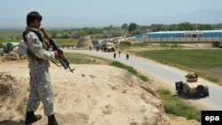 An Afghan soldier takes up a position during an ongoing battle with the Taliban in the northern Afghan city of Kunduz in May.