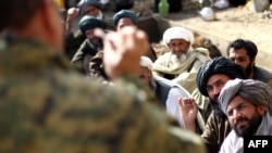 An Afghan army commander addresses tribal chiefs in Helmand Province on February 26.