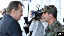 Haris Silajdzic (left), a member of Bosnia's tripartite presidency, arrives at EUFOR headquarters in Butmir on October 9.