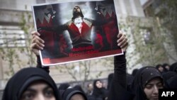 An Iranian student holds up a sign with a picture of a Bahraini protester in front of the Saudi Arabian Embassy in Tehran. Iran has been vocal in its criticism of Saudi actions against Shi'ite protesters in the Persian Gulf state.