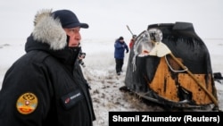 Roskosmos chief Dmitry Rogozin stands near a Soyuz capsule shortly after its landing in a remote area near the Kazakh town of Zhezkazgan in December 2018.