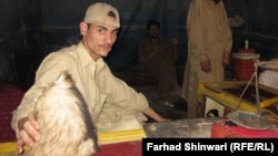 A hashish seller shows off his best-quality product, preserved in goatskin.