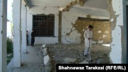 Locals and students inspect the ruins of a government girls high school destroyed by the Taliban in Bajaur Agency in June.