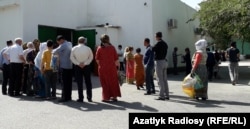 Turkmen line up outside food stores in Ashgabat waiting to buy vegetable oil, sugar, and flour.