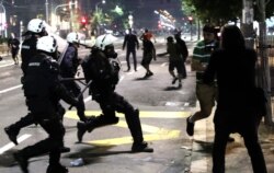 Police clash with protesters outside the Serbian parliament in Belgrade.