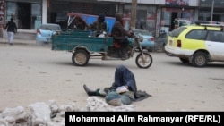 A woman begs on the streets of Sheberghan in northern Afghanistan.