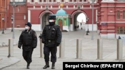 Russian police officers patrol a deserted Red Square in Moscow, which went into lockdown on March 30. 