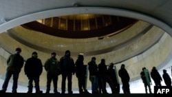 Vigilantes on both sides of the divide in Ukraine have formed groups to protect buildings that they control. In this picture, antigovernment activists protect Kyiv's "Ukrainian House," which was seized by protesters on January 26. 