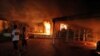 A vehicle and surrounding buildings burn after they were set on fire inside the U.S. Consulate compound in Benghazi, Libya, on September 11.