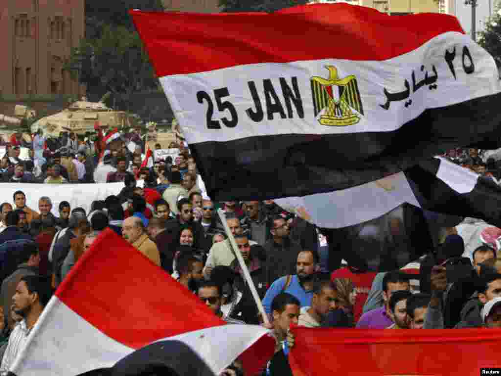 An Egyptian flag with January 25, the date the uprising started, written on it, is seen near tanks in Tahrir Square.