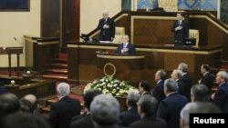 President Nursultan Nazarbaev (center on podium), members of the government, and freshly elected lawmakers stand for the national anthem before the inaugural session of the new Majilis in Astana on January 20.