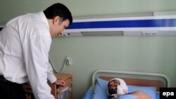 President Saakashvili visiting a patient at a military hospital in Gori on August 9