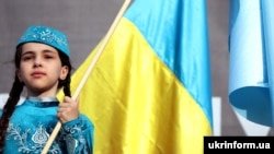 A girl in a national Crimean Tatar costume during a rally on the Day of Remembrance of the victims of the genocide of the Crimean Tatar people in Kyiv on May 18.