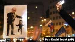 A poster depicts Russian President Vladimir Putin and Slovak Prime Minister Robert Fico at a rally in Bratislava last month. Ukraine's Volodymyr Zelenskiy accused Fico of taking "orders" from Russia.