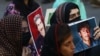 Relatives hold portraits of disappeared family members during a protest in Karachi on August 30.