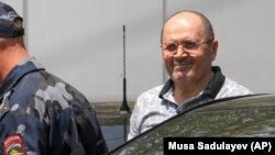 Oyub Titiyev, the jailed director of Memorial's office in Chechnya, leaves court after a hearing in Grozny on July 3, 2018.