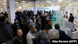 A large crowd of Iranians waits to get prescription drugs at a state-run pharmacy in Tehran in February.