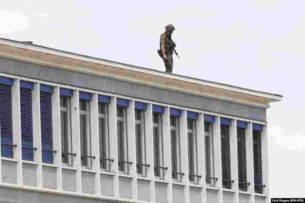 A soldier stands on the roof of a building near Geneva airport on June 15.&nbsp;