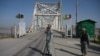 Afghan border police personnel stand guard on the Afghan side of the Afghanistan–Uzbekistan bridge in Hairatan. (file photo)