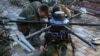 Ukrainian soldiers attach explosives to a Kazhan combat drone near Pokrovsk in the eastern Donetsk region.