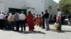 Long lines of people wait in front of a grocery store in Ashgabat to buy vegetable oil, sugar, and flour in late May.