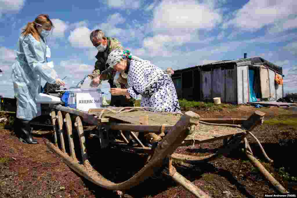 Residents of a remote Khanty cattle camp take part in early voting.