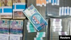 Tenge banknotes are seen at a bank branch in Almaty (file photo)