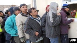 Afghan migrants wait for food aid in Calais, France. According to a recent report by the United Nations, one in four refugees in the world is from Afghanistan. (file photo)