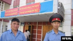 Two police officers guard a polling station in Bishkek.