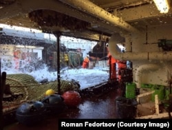 Fedortsov's crewmates work to haul in a net.