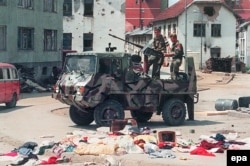 A picture dated July 16, 1995, shows Bosnian Serb fighters driving through the empty streets of Srebrenica after Ratko Mladic's troops had overrun this UN safe area the previous week.