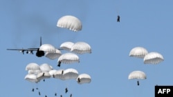 Polish troops land with parachutes at the military compound near Torun as part of the NATO Anaconda-16 military exercise in June.