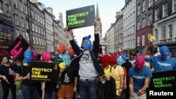 Protesters wearing Pussy Riot's signature balaclavas take part in an Amnesty International flash-mob demonstration in support of the punk group in Edinburgh, Scotland on August 14.