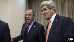 Russian Foreign Minister Sergei Lavrov (left) and U.S. Secretary of State John Kerry talk to reporters before their meeting in Beijing on November 8.