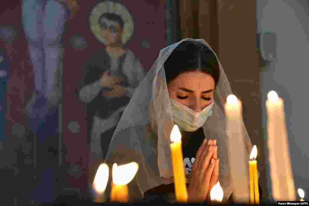 A woman prays in a church in Yerevan on October 17.