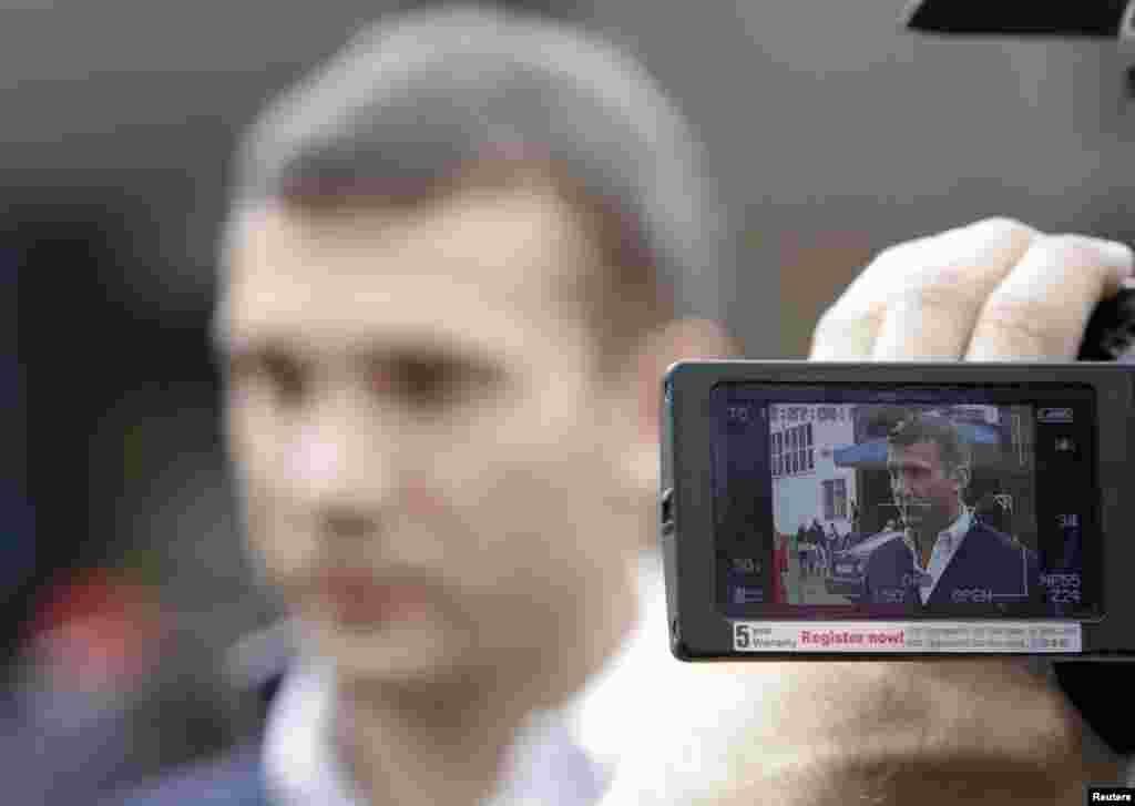 Former international soccer great Andriy Shevchenko, now a member of the pro-business Ukraine Forward! party, is seen on the monitor of a video camera while talking to the media on election day. (REUTERS/Vasily Fedosenko)