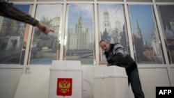 A local election commission member in Moscow prepares ballot boxes ahead of the start of voting across the country for a new State Duma on December 4.